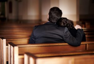 Two individuals sitting in a churh